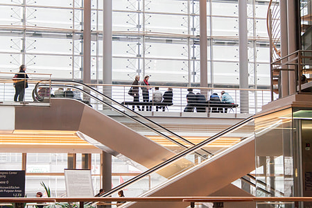 people standin beside railings near escalator thumbnail