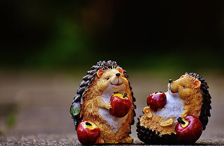 macro shot photography of two brown-and-black ceramic hedgehog figurines thumbnail