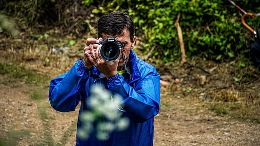 Man Taking Photo Near Woods thumbnail