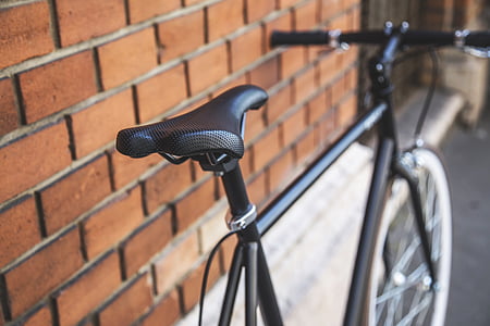 black mountain bike parked beside wall thumbnail