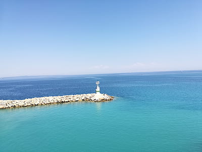 landscape photo of lighthouse surrounded by body of water thumbnail