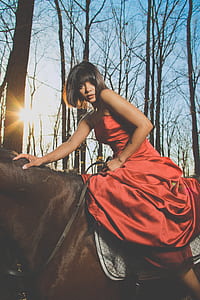 woman in red tube satin dress riding a horse thumbnail
