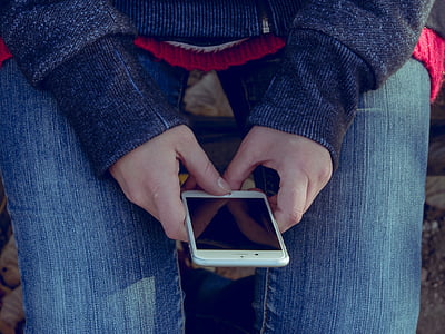 person holding silver iPhone 6 at daytime thumbnail
