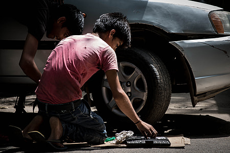 men fixing silver car thumbnail