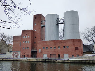 red and gray concrete building near body of water thumbnail