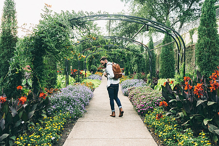 man walking on garden walkway thumbnail
