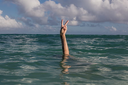 Hands Peace Sign In Water Photo thumbnail