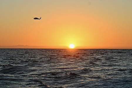 helicopter flying over sea thumbnail