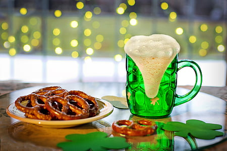 green glass beer stein and pretzel filled white plate thumbnail