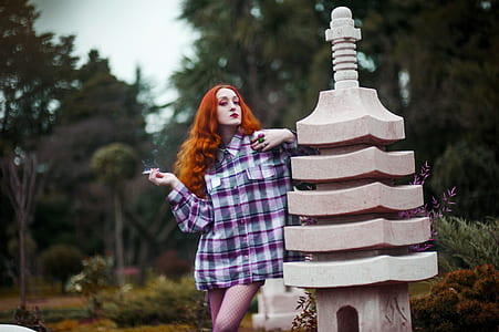 woman standing beside gray concrete pillar thumbnail