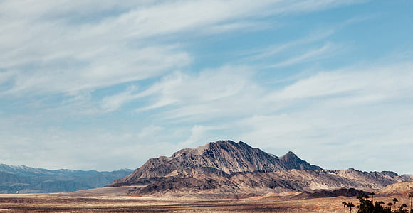 brown rock formation under blue calm sky thumbnail
