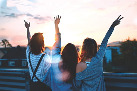 three women standing on bridge and pointing fingers thumbnail