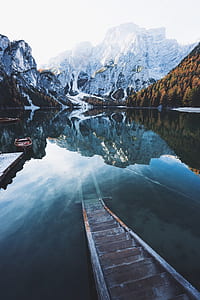 brown wooden staircase on body of water thumbnail