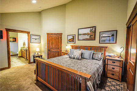 brown wooden bed with gray bedspread thumbnail