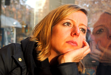 woman leaning on clear glass window thumbnail