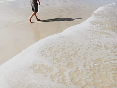 person walking near seashore thumbnail