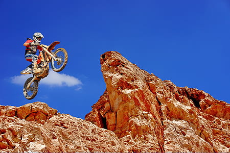 person on dirt bike jumping off from cliff thumbnail