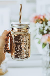 Person Holding Brown Mason Jar Mug thumbnail