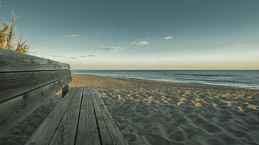 brown wooden bench in the beach thumbnail
