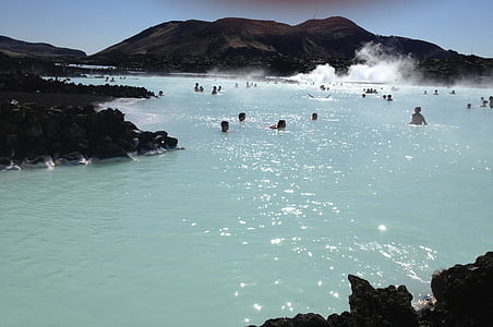 people swimming on body of water thumbnail
