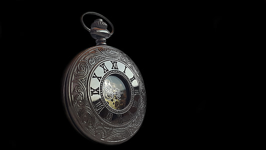 round silver-colored framed pocket watch with black background thumbnail
