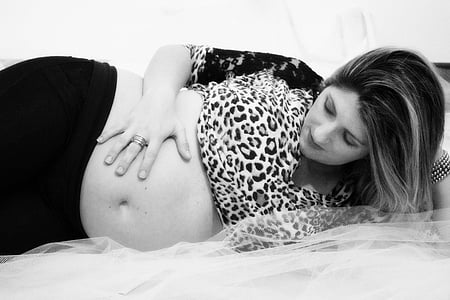 pregnant woman lying on bed thumbnail