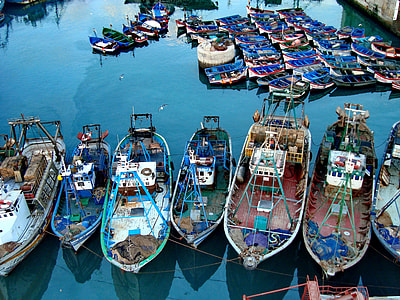 red and blue boats on body of water at daytime thumbnail