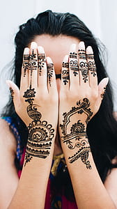 woman showing mehndi tattoo thumbnail