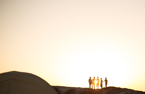 silhouette of five person standing on mountain thumbnail