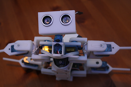 close-up photo of robot on brown wooden surface thumbnail