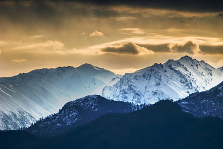 gray mountain under cloudy sky thumbnail