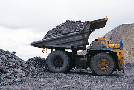 yellow and gray haul truck carrying sand and soil thumbnail