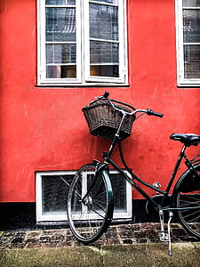 black city bicycle beside red wall thumbnail