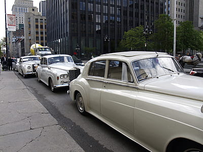 three cars parked on street near high-rise building thumbnail