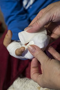 person holding white gauze thumbnail