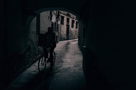 person riding bicycle in grayscale photography thumbnail