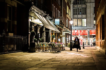 woman walking on alley beside store with awnings thumbnail