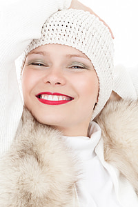 woman wearing white knit hat and white fur-lined coat thumbnail