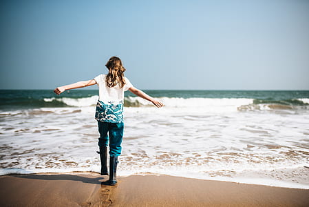 woman standing near beach during daytime thumbnail