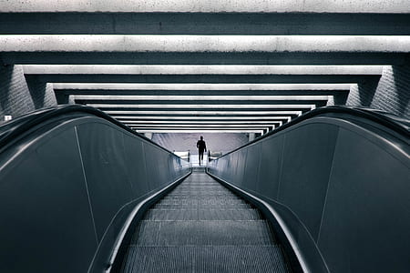 person standing in front of escalator thumbnail