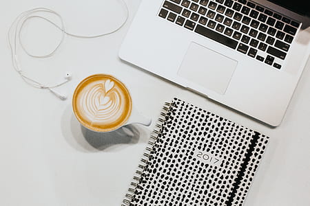 MacBook Pro beside white ceramic mug thumbnail