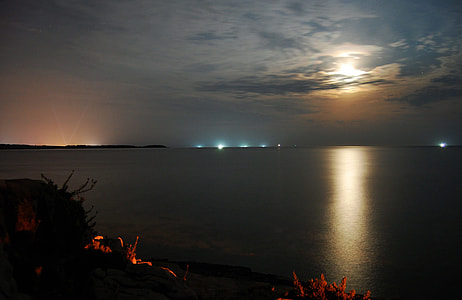 view of body of water under moonlight thumbnail