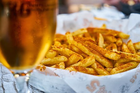 potato fries in glass bowl beside wine glass thumbnail