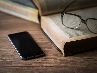space gray iPhone 6 near eyeglasses and book thumbnail