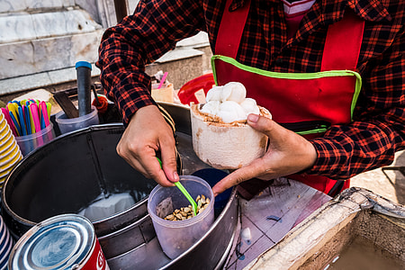 Serving fresh coconut ice cream in young coconut thumbnail