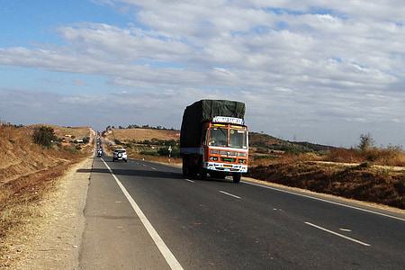 orange and white truck on road during daytime thumbnail