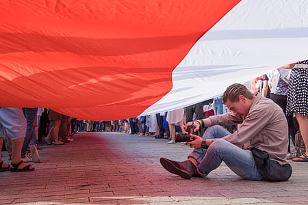 man sitting under flag thumbnail