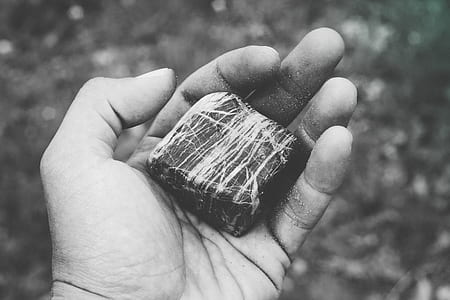 person holding square stone fragment thumbnail