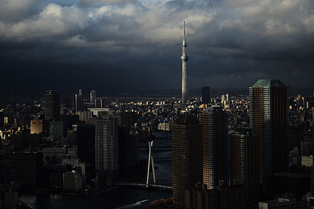 landscape photography of tower under cloudy skies thumbnail