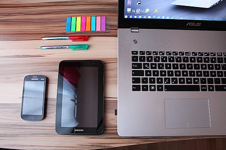 gray Asus laptop near black tablet computer thumbnail